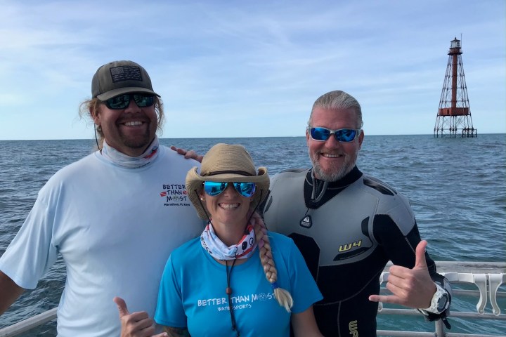 a group of people standing next to a body of water