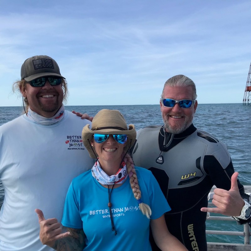 a group of people standing next to a body of water
